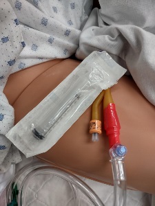 draped manikin thigh with 10ml luer lock syringe in packaging
