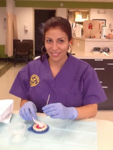 nursing student painting a clay would model