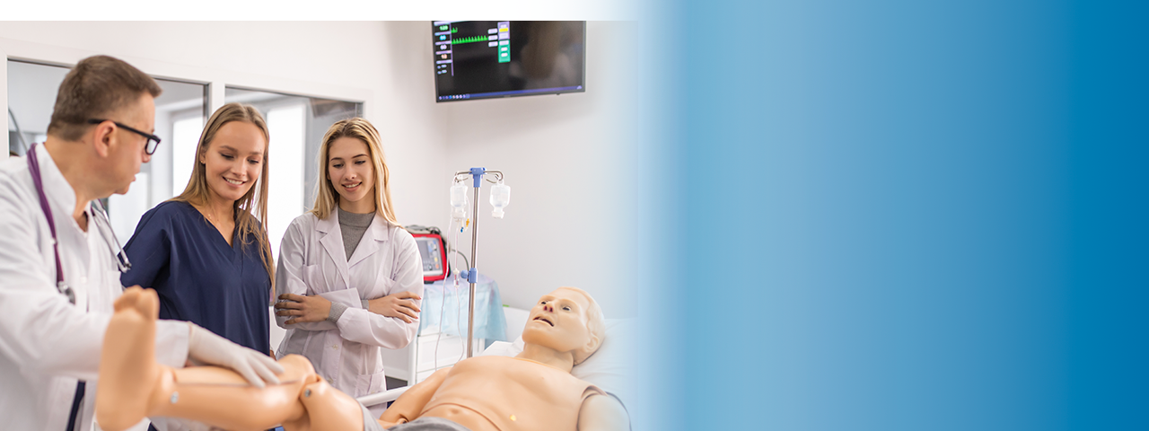 Instructor and two nursing students with a manikin