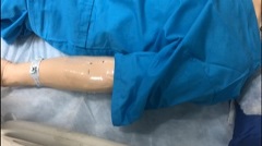 manikin arm with shrink wrap tube adhered to antecubital fossa