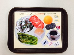 food tray with laminated paper showing food on a plate with additional food and drinks to the side of the plate
