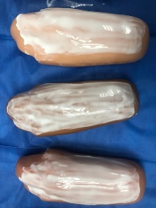 three manikin arms covered with wet white liquid school glue