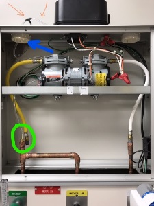 Hospital bed headboard with vent removed indicated by blue arrow. Orange arrows point to two pieces of 5" tubing onto the T-connector. A green circle indicates where where tubing needs to be routed through internal holes in the headboard.