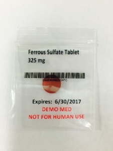 2" x 2" clear plastic zippered bag with one red table inside. Bag says "Ferrous Sulfate Tablet 325 mg"