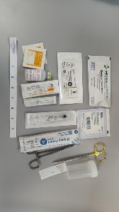 A collection of supplies including including syringes, alcohol pads, a vial of bacteriostatic water, a biopsy punch, scissors, a specimen container, a ruler, and packaged needles and swabs