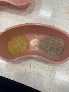 kidney shaped basin containing 7 teaspoons of unsweetened applesauce and 7 teaspoons of chocolate instant pudding mix