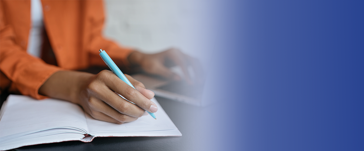 Website Banner Image Color Closeup view of a person writing in a book