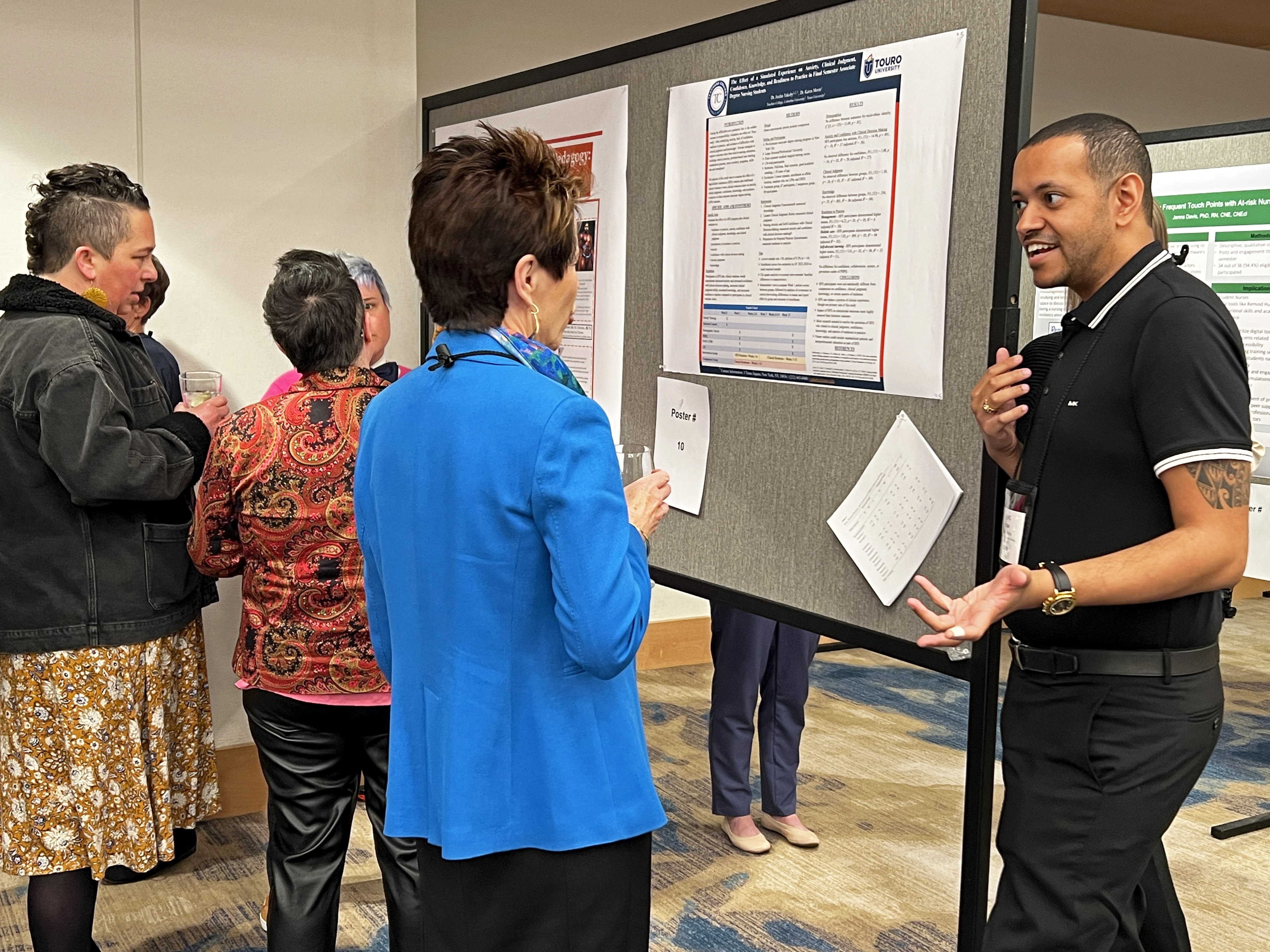 NERC poster presentation 2 A nurse educator discusses their poster presentation with a colleague
