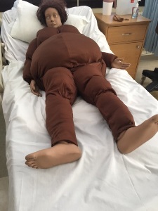 manikin wearing an obesity suit in a hospital bed