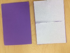 one purple adhesive craft foam sheet and one adhesive craft foam sheet with removable backing exposed