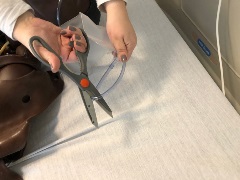 person cutting tubing with scissors