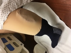 manikin calf with red pocket between the fabric "skin" and foam of an edema legging